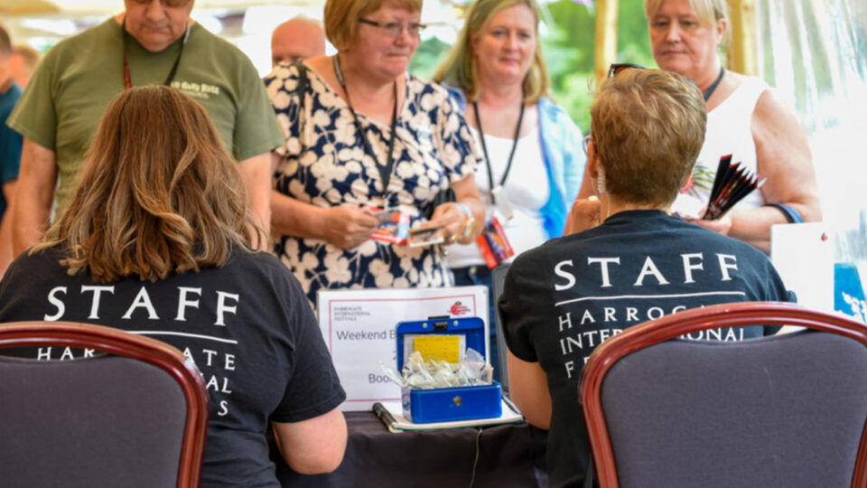Staff members sat at the sign in table welcoming visitors to the festival.