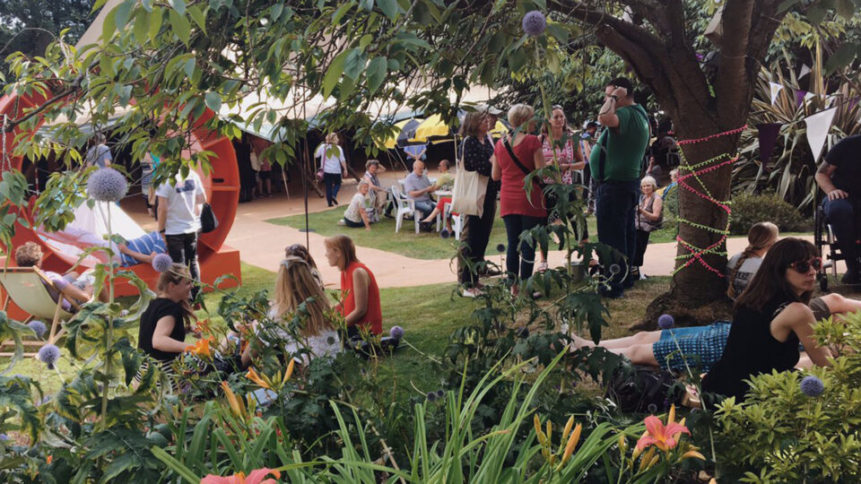 People sitting in the park at the Crime Festival.