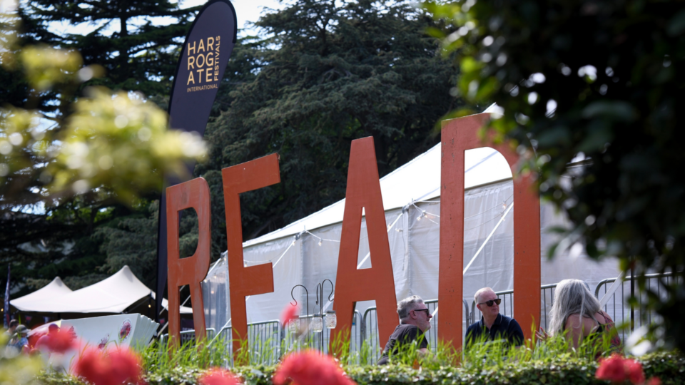 The festival branding outside a marquee tent.