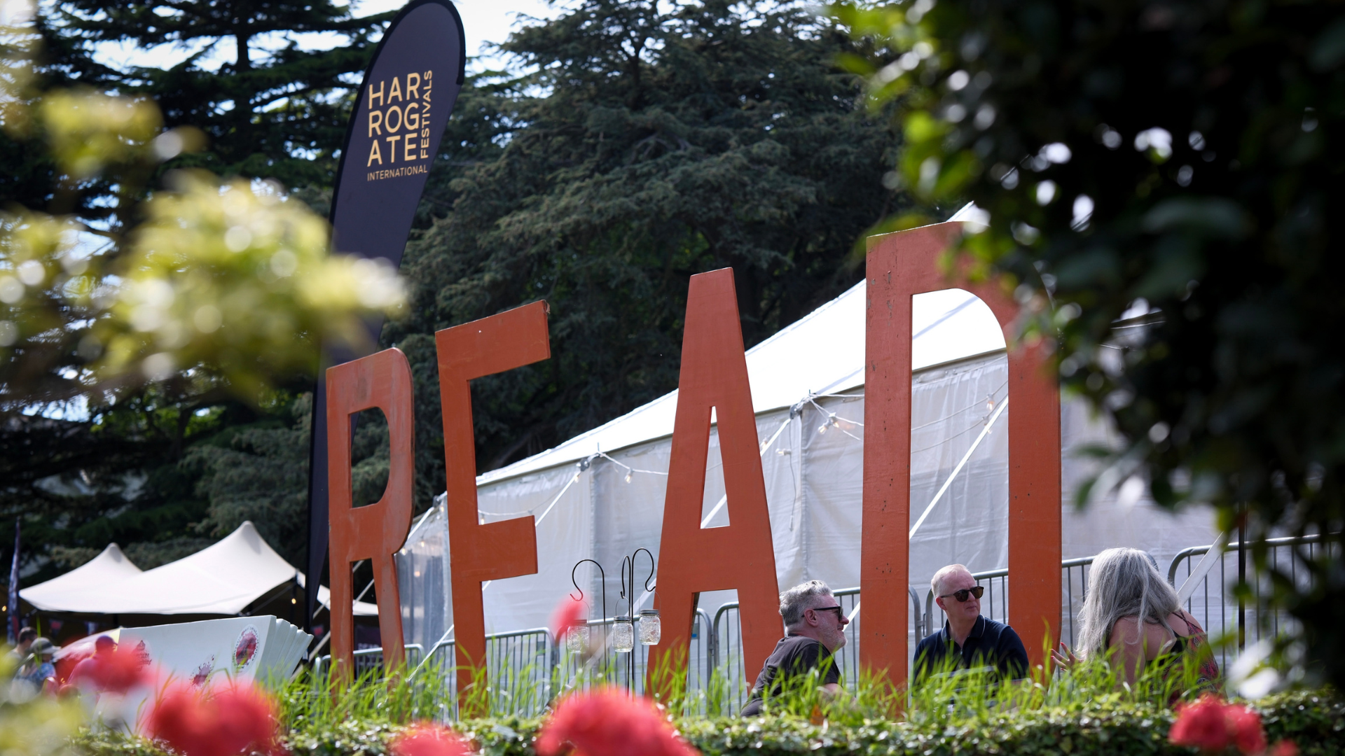 The festival branding outside a marquee tent.