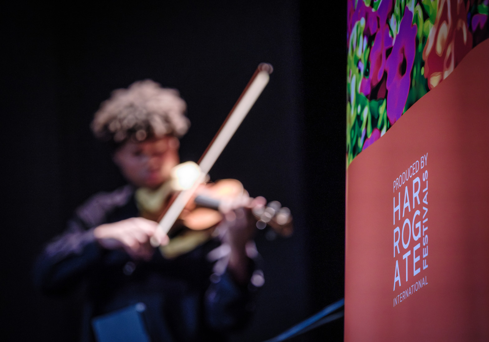 A violin player onstage performing at HIF.
