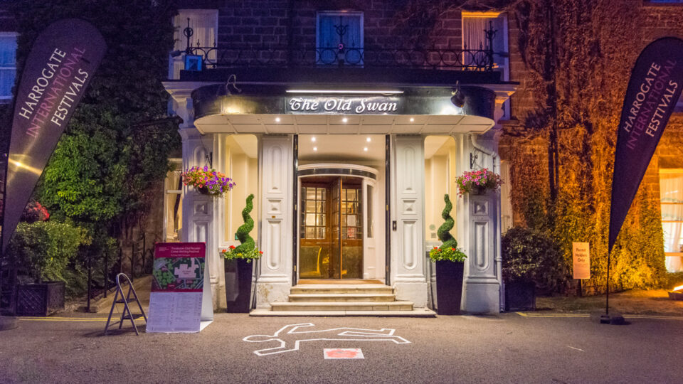 The outside of The Old Swan hotel during the Old Peculier Crime Writing Festival. There is a chalk outline of a body on the concrete floor like what you would find at a crime scene.