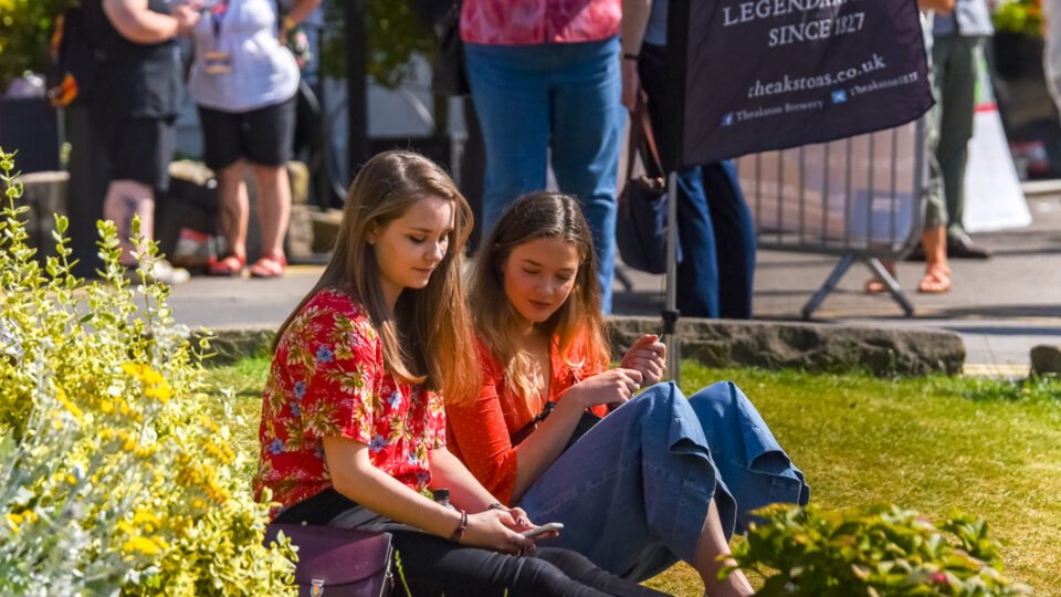 People sat outside on the grass.
