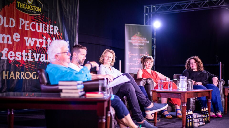 The New Blood panel sitting on the festival stage with Val McDermid.