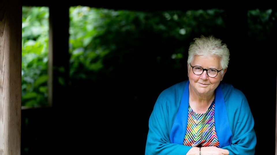 Val McDermid, author posing outdoors for the camera.