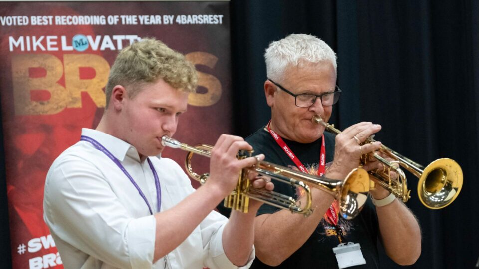 A couple of men playing trumpets.