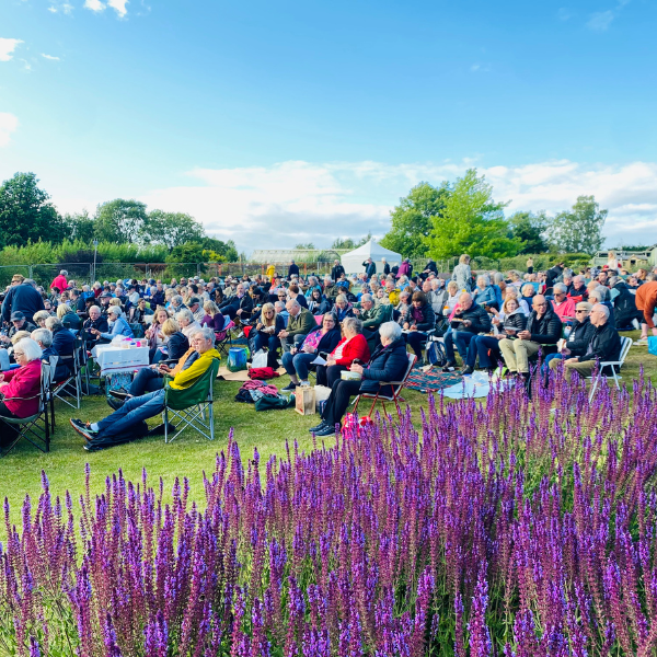 The audience watching an Oddsocks performance in the RHS Harlow Carr gardens.